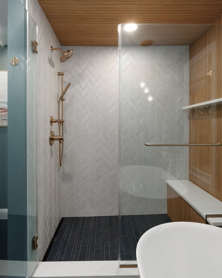Glass Shower Enclosure with Chevron Tile & Gold Hardware